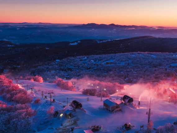 A sun sets over a ski resorts