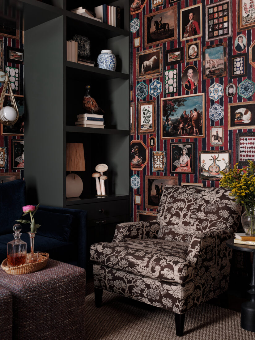 A printed chair against a striped print wall with gallery-hung artwork