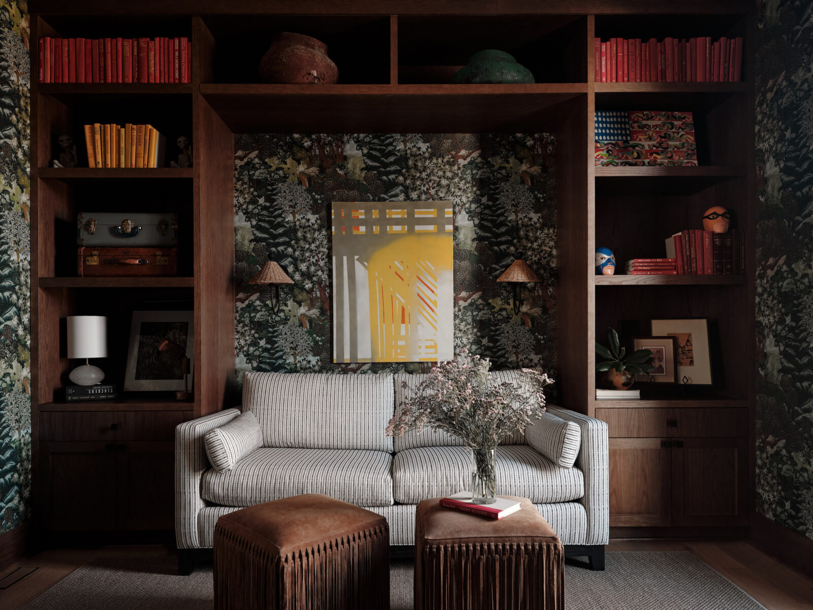 Woody/floral wallpaper in a den with a striped couch