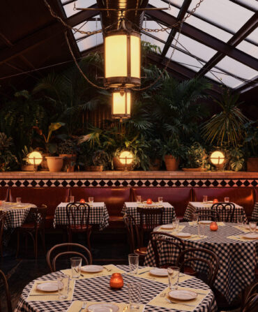 Inside a restaurant with big ceiling windows and checkered tables