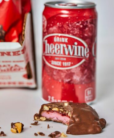 A can of soda and a piece of chocolate candy