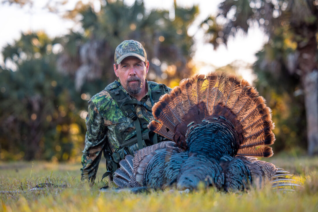 A man sits with a turkey
