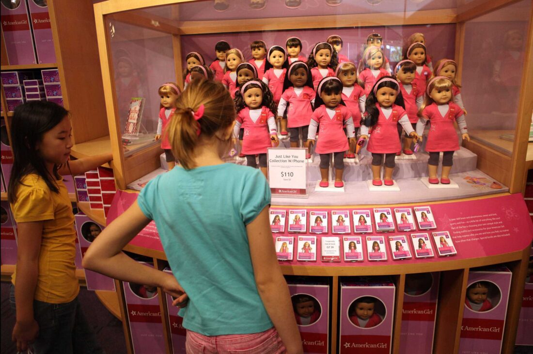 Girls look at American Girl dolls