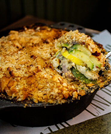 A slice of squash casserole in a skillet