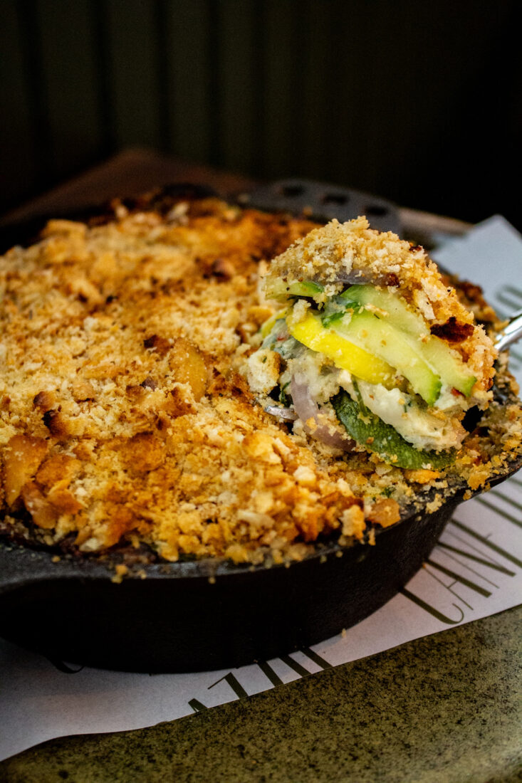 A slice of squash casserole in a skillet