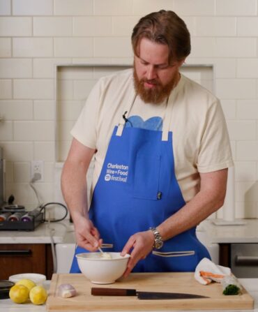 A chef preparing a dish in a kitchen
