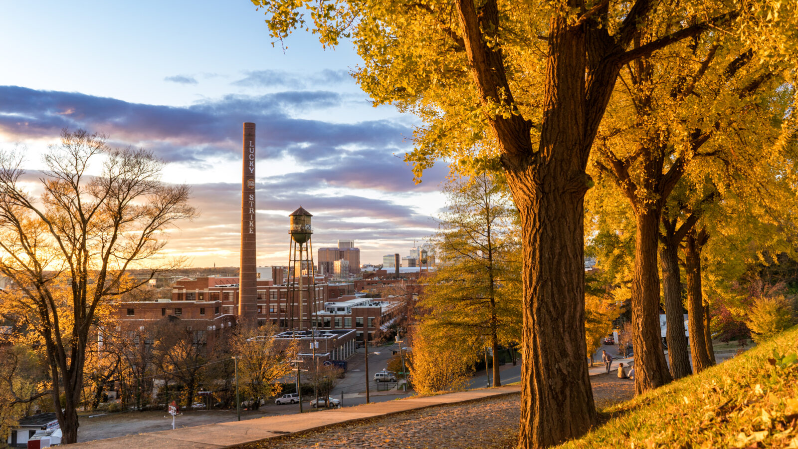 The sun sets over a city skyline
