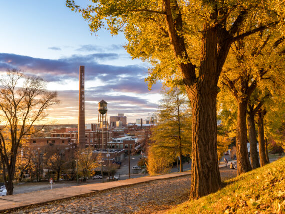 The sun sets over a city skyline