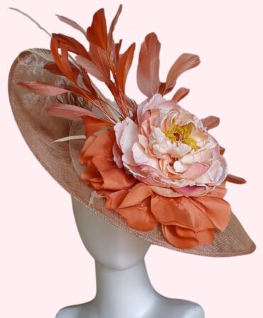 A beige hat with coral and light pink accents