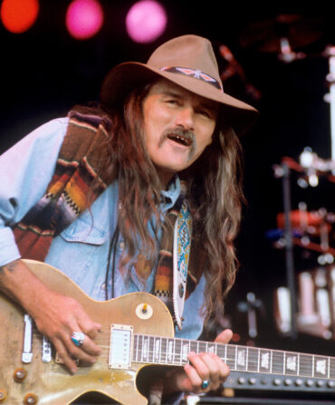 Dickey Betts plays his guitar on stage
