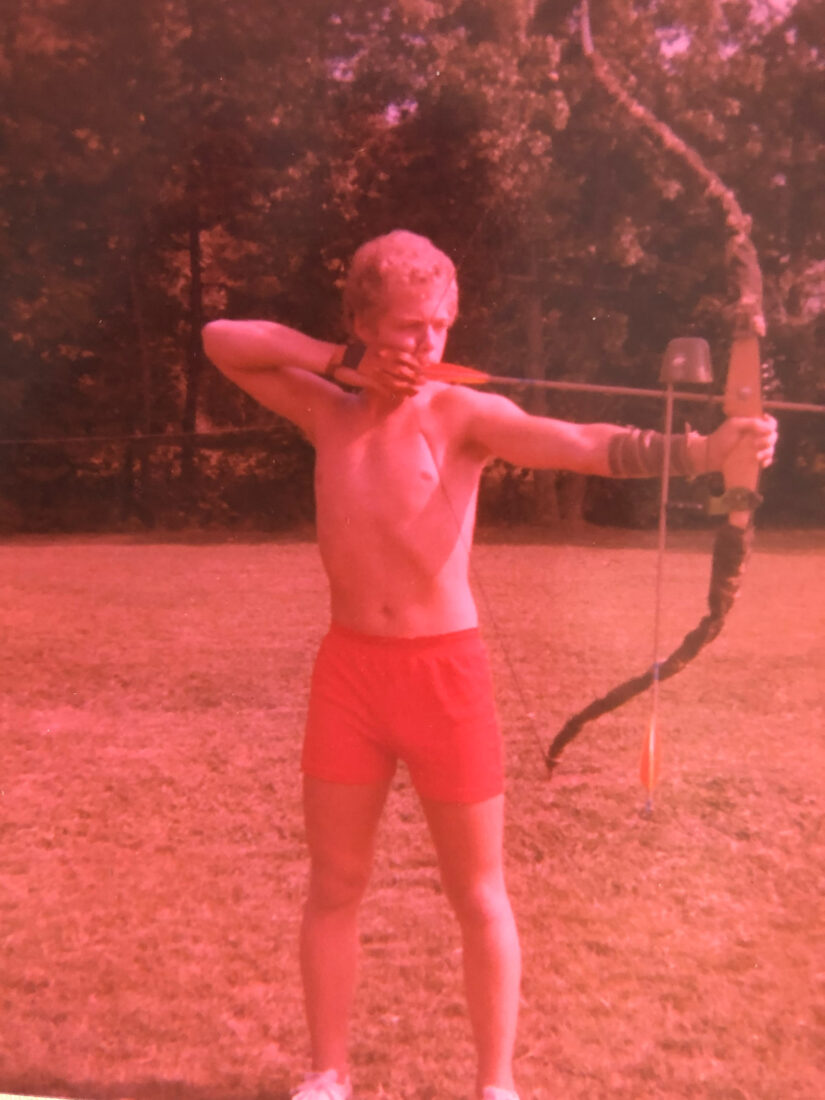 A boy aiming a bow and arrow