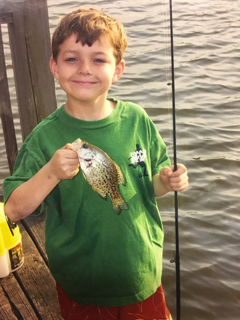 A boy holds a fish