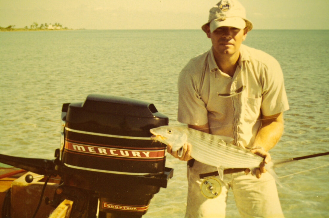 A vintage photo of a man holding a fish