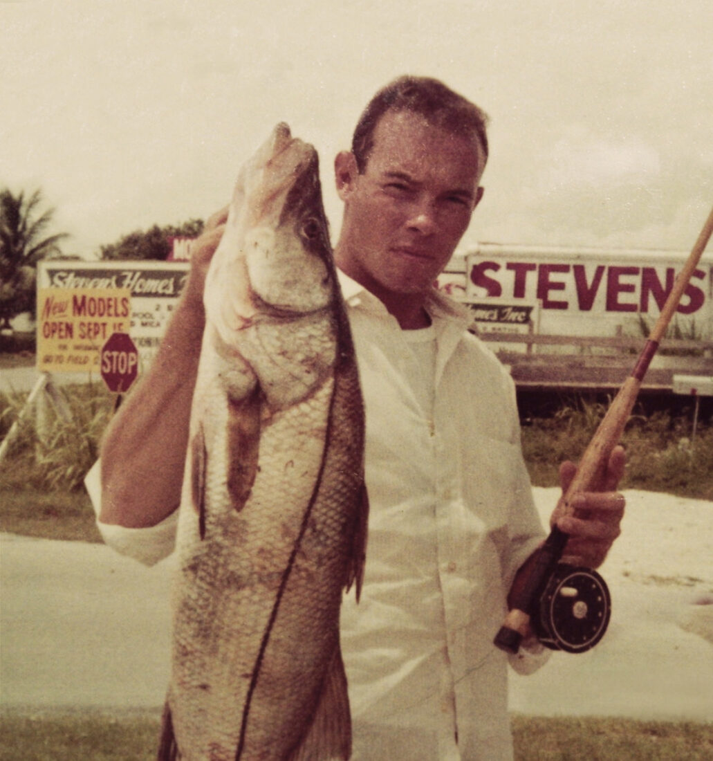 A vintage photo of a man holding a fish