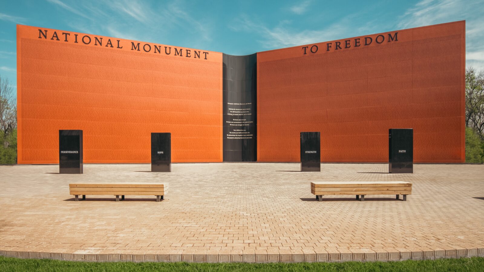 A wall-shaped monument, inscribed with approximately 122,000 names