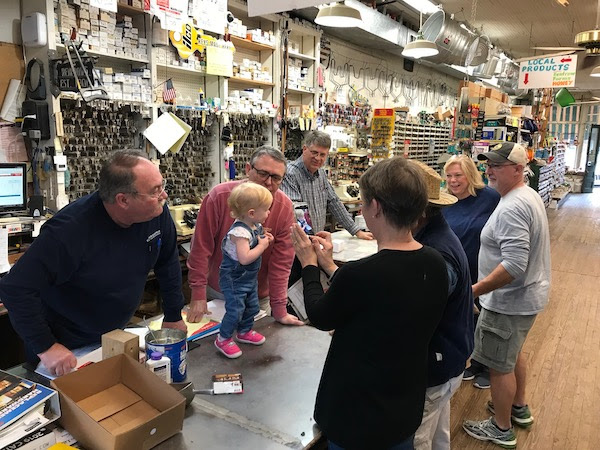 People gather at the front counter of a store