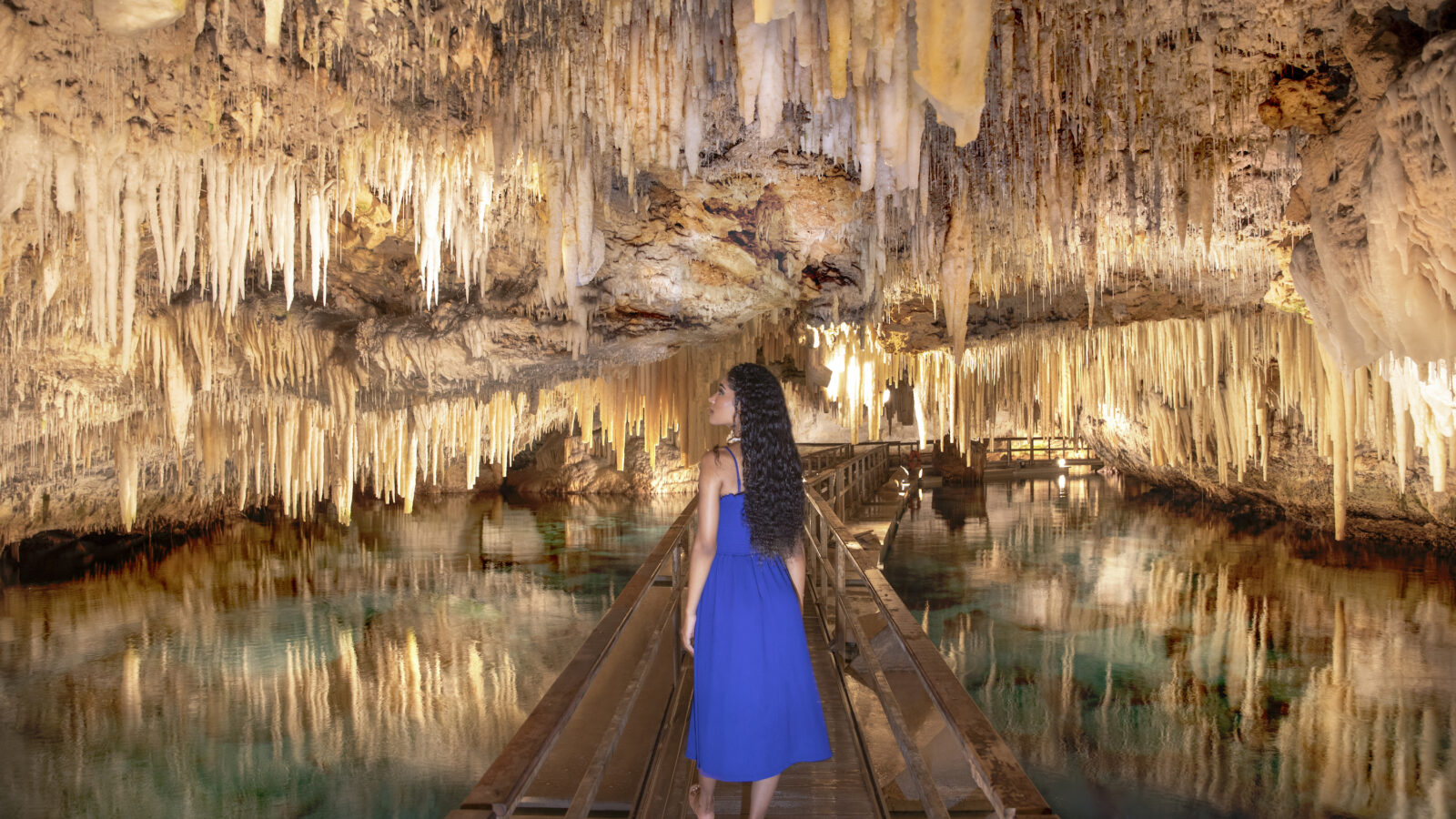 A woman walks down a cave system