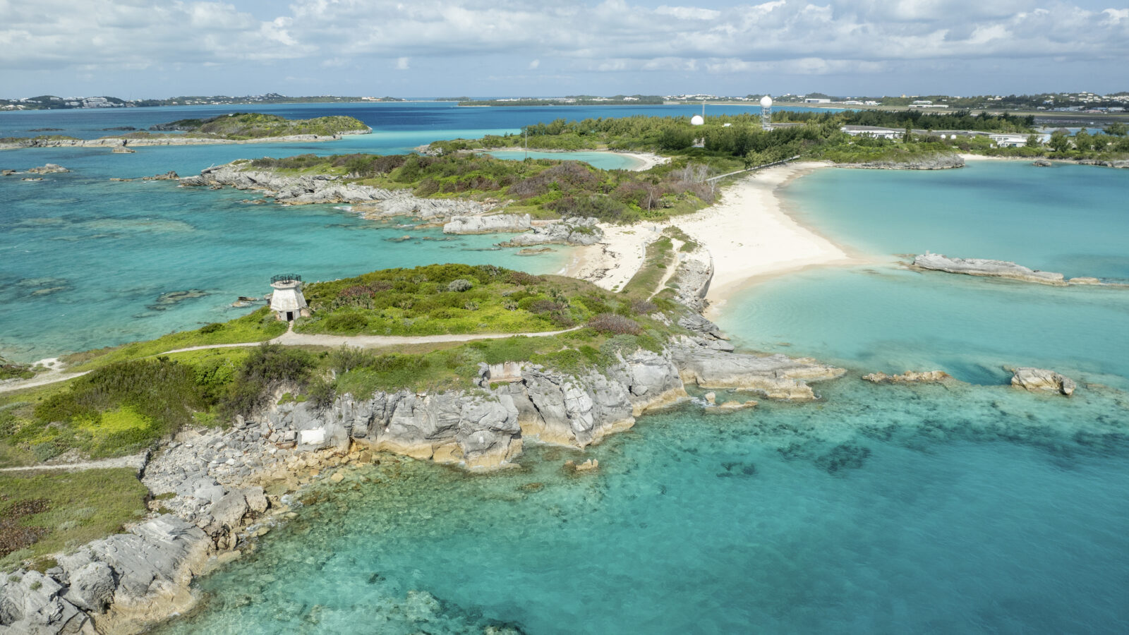An island with white sand beaches and clear water