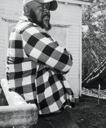 A portrait of a man in a checkered shirt