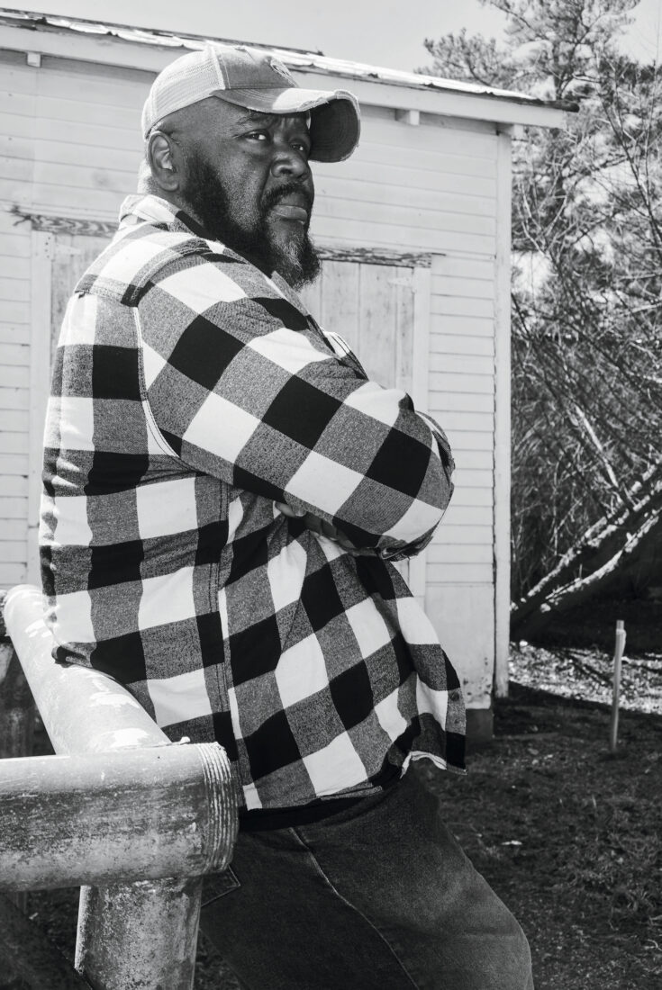 A portrait of a man in a checkered shirt