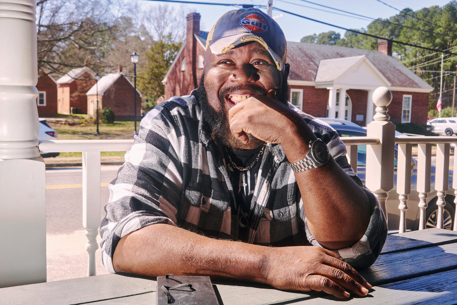A portrait of a man sitting with a notebook