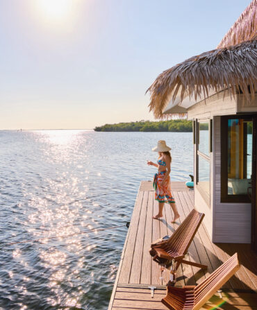 A woman stands on a floating dock on the water