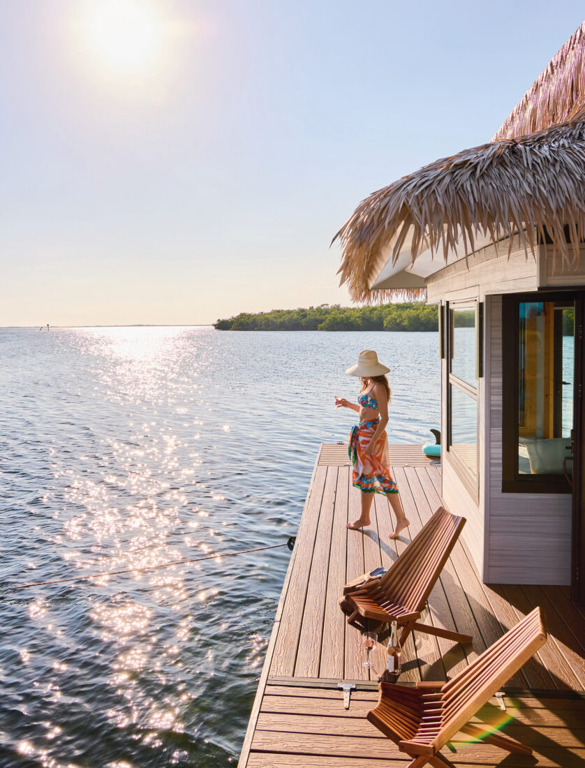 A woman stands on a floating dock on the water