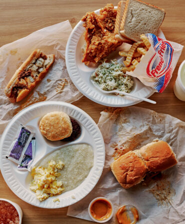 A breakfast plate, fried chicken and sides, a chili dog, and chili burgers.