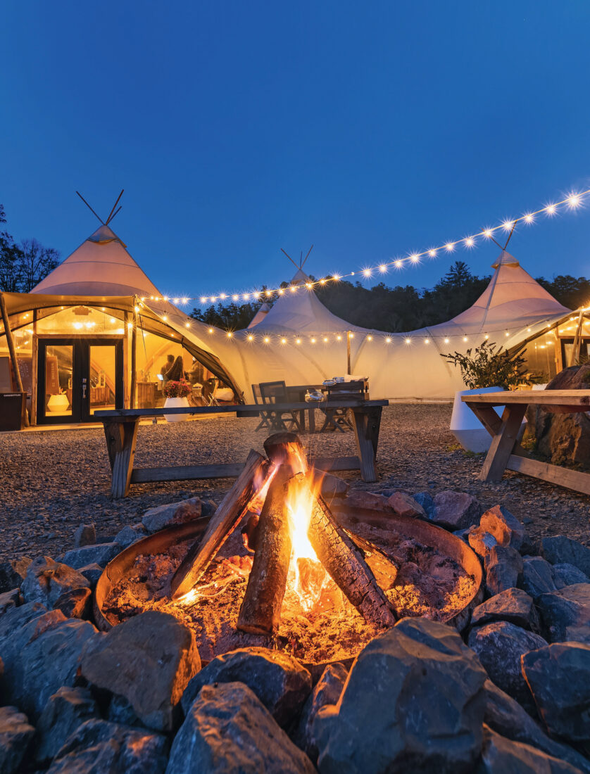 A campsite with a fire at night