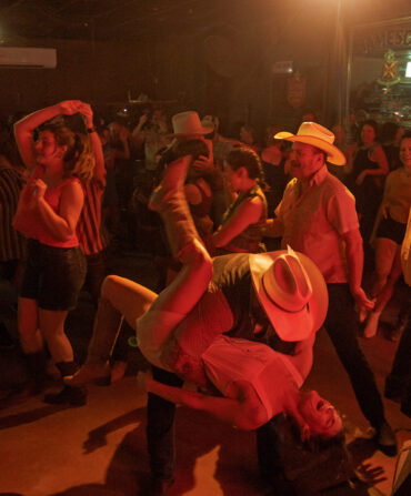 A couple dips in a dance floor