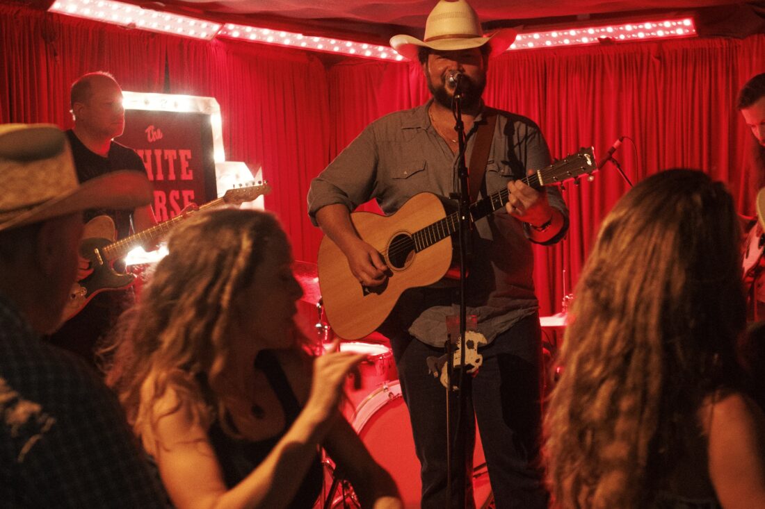 People dance in front of a stage
