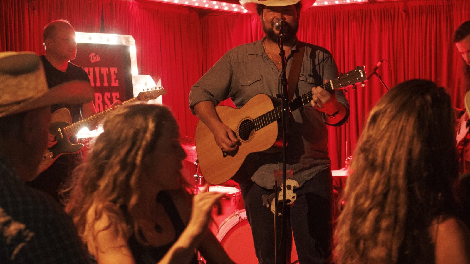 People dance in front of a stage