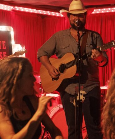 People dance in front of a stage