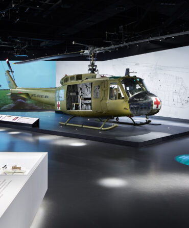 A helicopter in a military exhibit in a museum