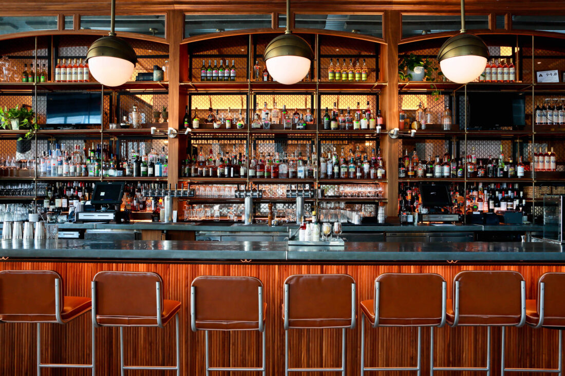A polished bar with warm wood and darker accents