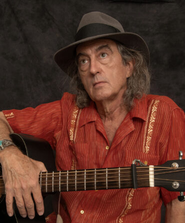 A portrait of a man with a guitar