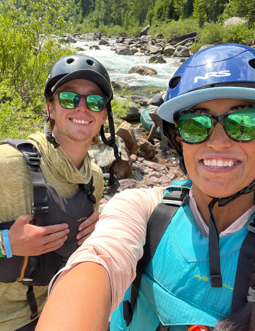 A woman and man on the back of a river