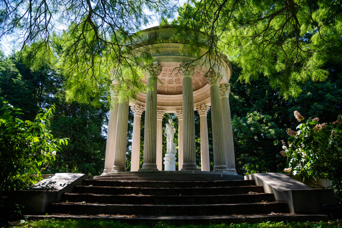 A white temple structure in a garden