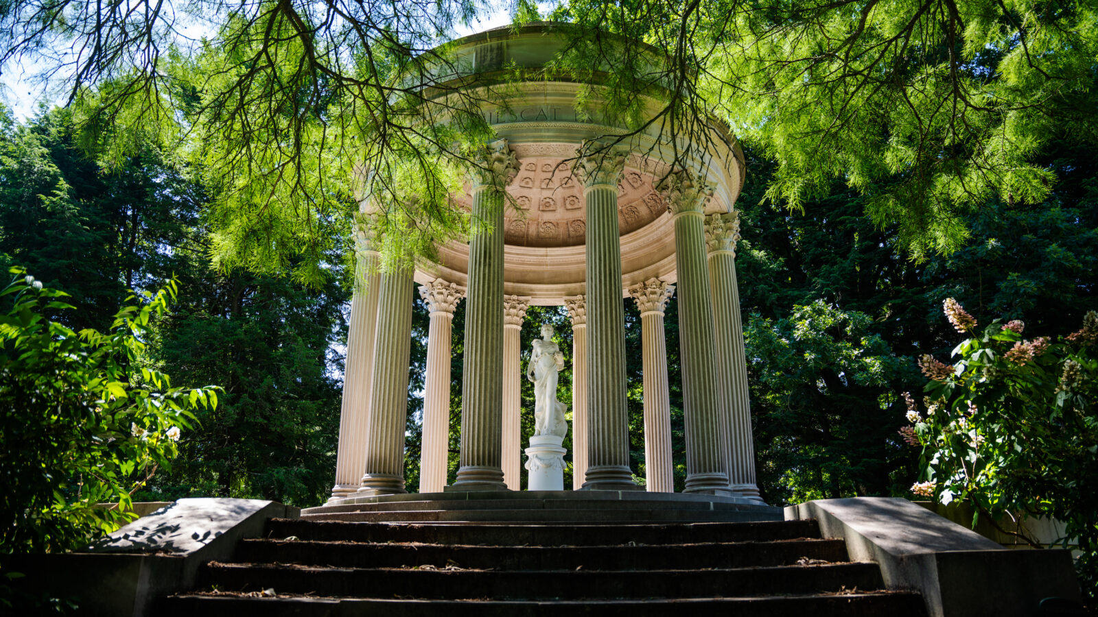 A white temple structure in a garden