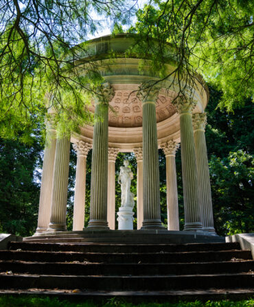 A white temple structure in a garden