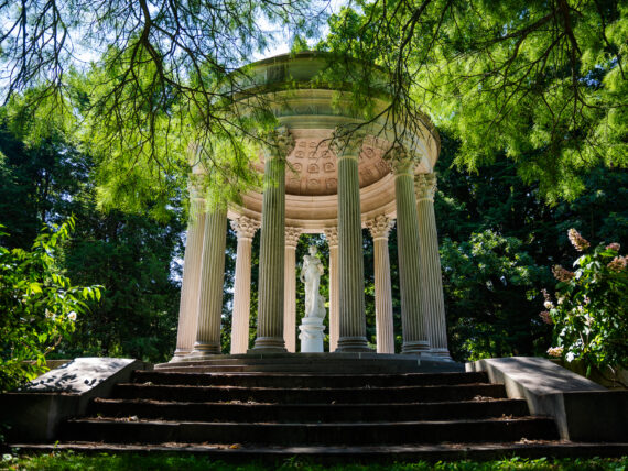 A white temple structure in a garden