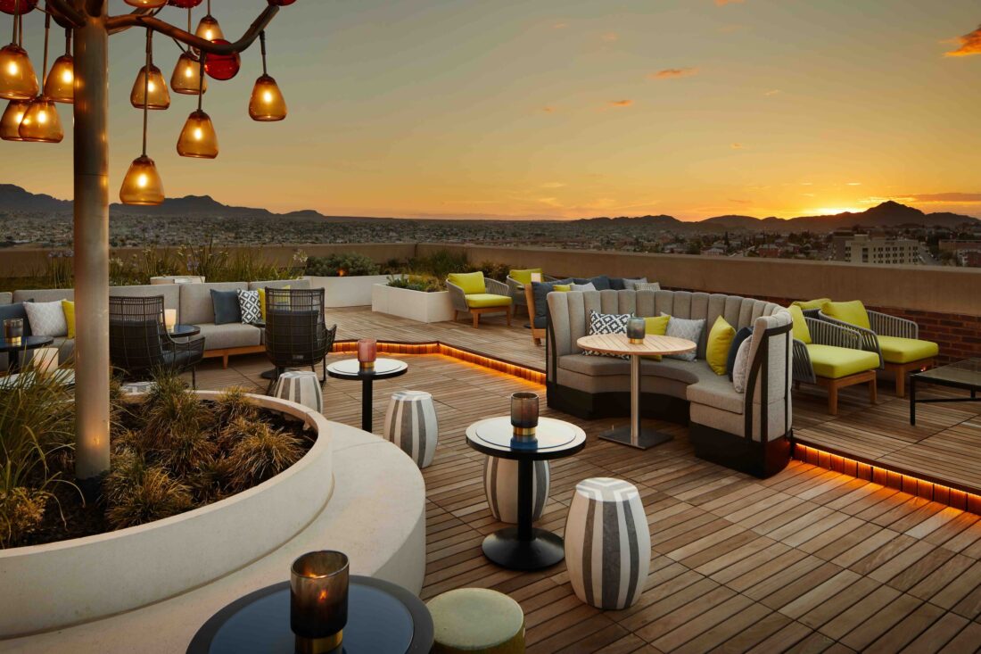 Rooftop bar seating at sunset
