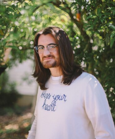 A portrait of a man under a tree