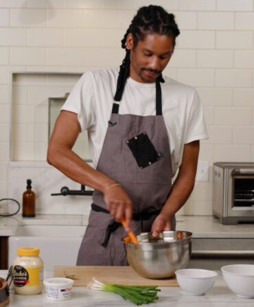A chef preparing a dish in a kitchen