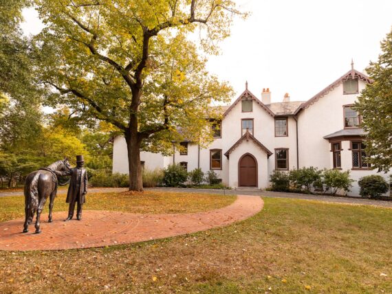 The front of a white house with brown trim and details