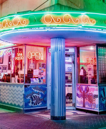 Outside a cafe with neon signs