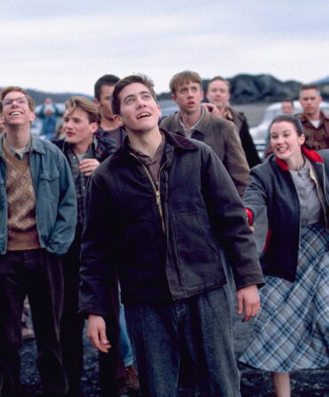 A group of teens look up at the sky