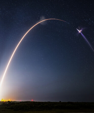 A rocket launches into a night sky