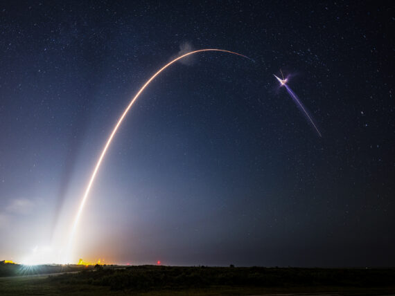 A rocket launches into a night sky