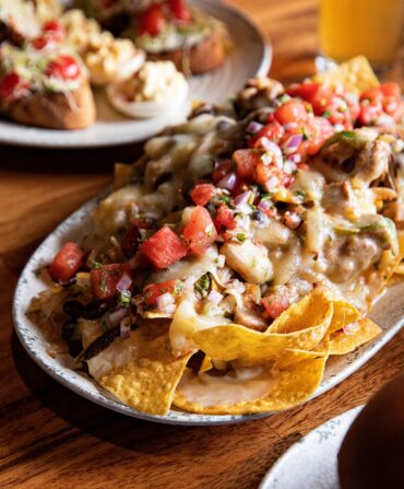 A nacho appetizer topped with watermelon pico de gallo